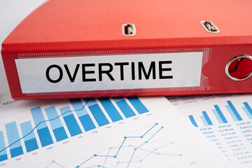 Overtime. Binder data finance report business with graph analysis in office.