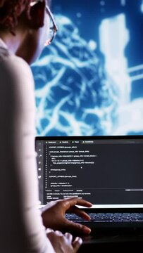 Vertical video Proactive IT consultant writing artificial intelligence script code in startup workspace on tablet terminal. Competent inspector doing maintenance work in high tech facility updating AI