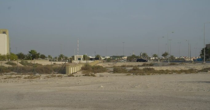 Universities and highways near oil field in desert in Riffa