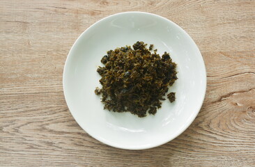 stir fried pickled mustard or Gan Lan Cai Chinese food made from cabbage and black olive in oil on plate