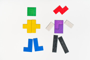 Fototapeta premium Abstract boy and girl collected from puzzle. Kids toys. Colorful educational wooden toys on white background. Montessori Games. Child Development.