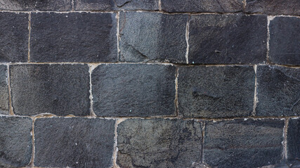 Old stone wall close up in soft beige palette. Stone tile background with detailed natural texture. Historical building facade. Easily add depth and organic texture to your designs.