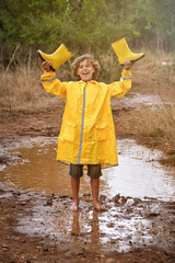 Happy boy under rain in countryside