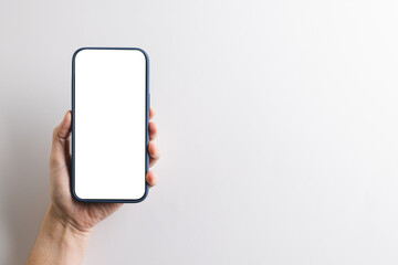 Hand of caucasian woman holding smartphone with blank screen and copy space on white background