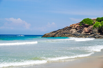 Beautiful Scenery of Sea waves with rock mountain in the background