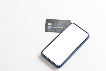 Smartphone with blank screen and credit card on white background