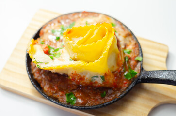 Hand rolled four cheese ravioli pasta in minced beef with Chianti red wine, garlic and herb ragu, and a bechamel sauce topped with pecorino cheese crumb and finished with fresh parsley