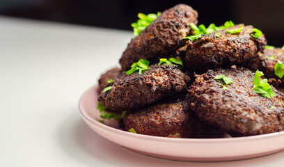 Fried minced cutlets served in a pile on a plate, typical eastern european homemade food