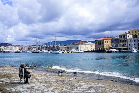 an elderly woman looks at the city and the bay
