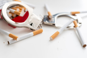Stop smoking concept. Cigarettes in handcuffs.