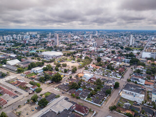 Beautiful aerial drone view of Porto Velho city center skyline, streets, squares. Amazon rainforest in the background on cloudy summer day. Rondonia state, Brazil.