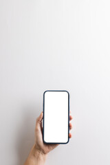 Vertical image of caucasian woman holding smartphone with blank screen on white background