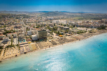  Golem, Durres, Albania - 22 august 2023: Aerial view to sandy beach full of umbrellas and people...