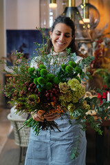 Happy woman demonstrating flower bouquet