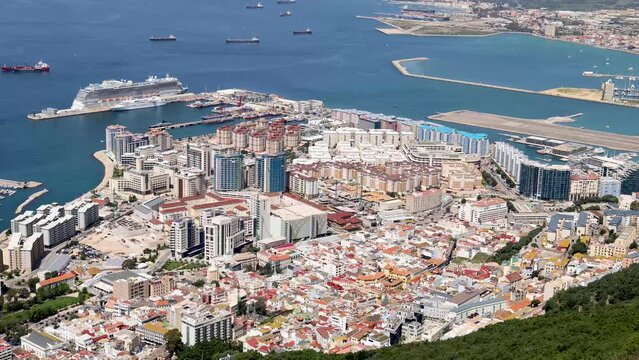 Footage at the top of the the famous Rock of Gibraltar in the summer time showing the city and harbour on a sunny day in the summer time