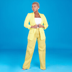 Corporate, business woman and entrepreneur in studio assertive for career, job and startup on blue background. Professional, fashion and creative young person with confidence, pride and ambition