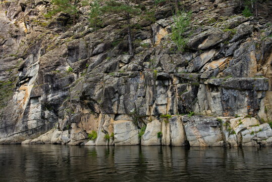 Russia. Chita region. Coastal rocks on the Burkal River, whose fast waters tend to the Selenga River and further into Lake Baikal.