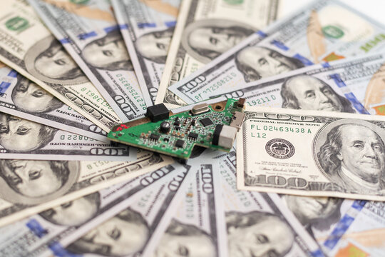 Electronic circuits, microchips, substrates for technology with dollars lying nearby. Electronics cost concept