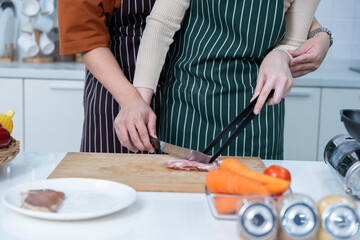 close up hand of asian of chopping vegetables preparing food and enjoy cook cooking with vegetables, meat, bread while standing on a kitchen Condo life or home