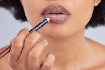 Makeup, cosmetics and lips of woman with pencil in studio for wellness, skincare product and...