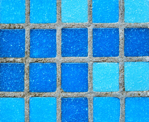 Blue tiled pool surface mosaic texture as background
