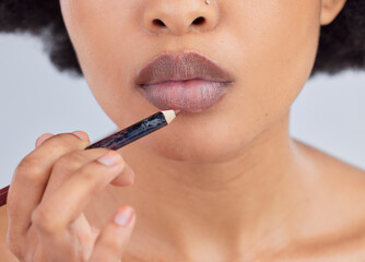 Makeup, beauty and lips of woman with pencil in studio for wellness, skincare product and...