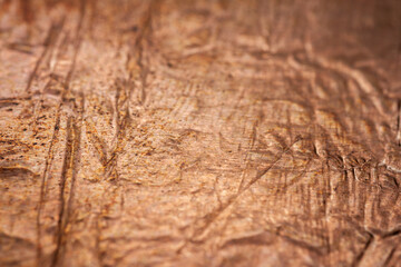 Extreme closeup of crumpled brass foil texture