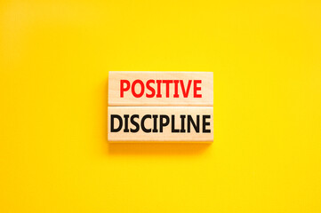 Positive discipline symbol. Concept words Positive discipline on beautiful wooden blocks. Beautiful yellow table yellow background. Business psychology positive discipline concept. Copy space.