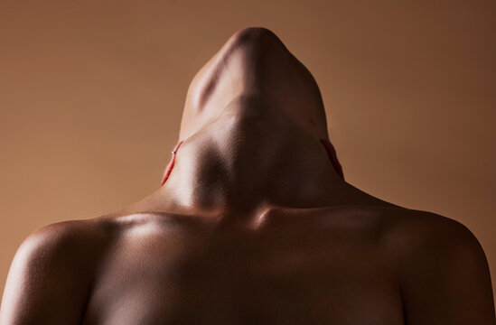 Skincare, cosmetics and closeup with neck of person in studio for health, textures and beauty. Wellness, body and aesthetic with zoom of woman on brown background for glow dermatology and glamour