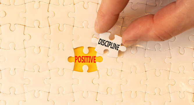Positive discipline symbol. Concept words Positive discipline on beautiful white paper puzzles. Beautiful yellow paper background. Business psychology positive discipline concept. Copy space.