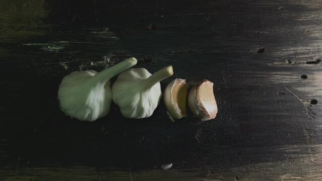 Two garlic passes top view on a wooden background.
