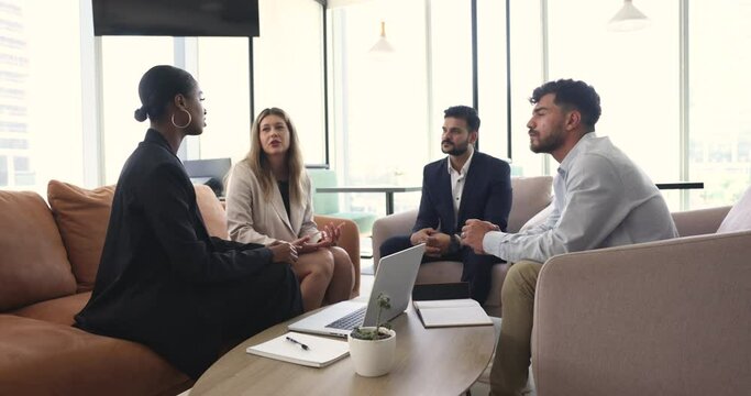 Businesspeople, business parties or partners discuss, negotiate and planning future cooperation. Millennial staff members engaged in morning briefing, decide current issues gather in modern workspace