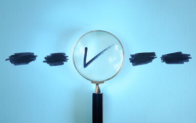 Magnifying glass enlarging the correct choice or check mark on blue background. Business...
