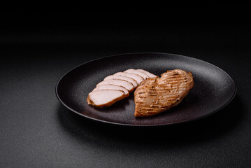 Delicious juicy grilled chicken fillet with salt, spices and herbs
