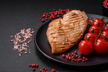 Delicious juicy grilled chicken fillet with salt, spices and herbs