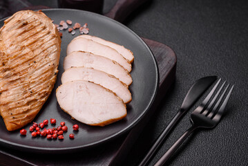 Delicious juicy grilled chicken fillet with salt, spices and herbs