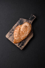 Delicious juicy grilled chicken fillet with salt, spices and herbs