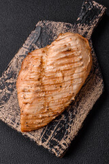 Delicious juicy grilled chicken fillet with salt, spices and herbs