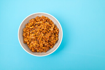 Bowl of boiled red lentils in a ceramic bowl