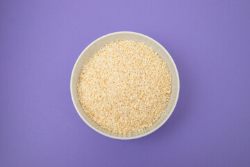 Coconut flakes in white small bowl