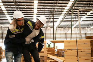 Lumber warehouse worker injured in leg, Colleagues help and support to go to the first aid room for treatment.