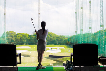Woman practice golf in golf driving range