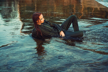Girl dressed as a pilot in the water summer 2023