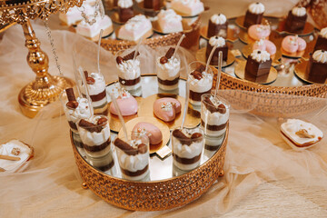 A delicious wedding. Candy bar with various chocolates. Fruit table. Celebration concept. Fashionable desserts. Table with sweets, candies.