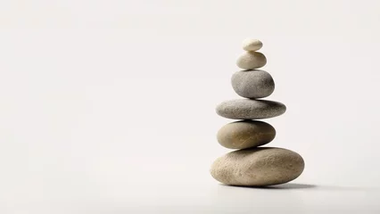  Minimalistic stone arrangement representing Zen philosophy. Balanced stones evoke peace and harmony, symbolizing inner stillness and meditation. Neutral beige color tones. Copy space © Garnar
