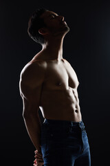 Bodybuilder man, shirtless and studio profile with wellness, healthy body and black background. Young guy, fitness and silhouette in dark, thinking and strong with ideas, health and topless for art