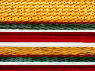 Temple canopy displays glossy tiles in varied colors, formed in a curved layout.