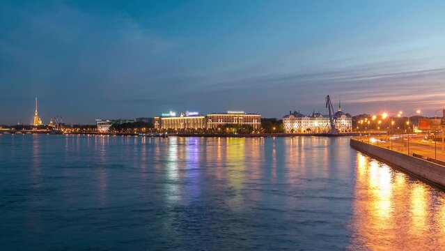 Day to night timelapse showcases Nakhimov Naval School and Peter and Paul Fortress, viewed from Liteyniy Bridge in St. Petersburg. Aurora's absence, reflected in Neva's waters, adds to the spectacle