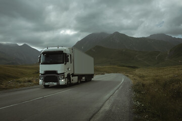 semi truck driving through mountain road pass