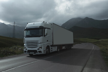 Fototapeta na wymiar semi truck driving through mountain road pass